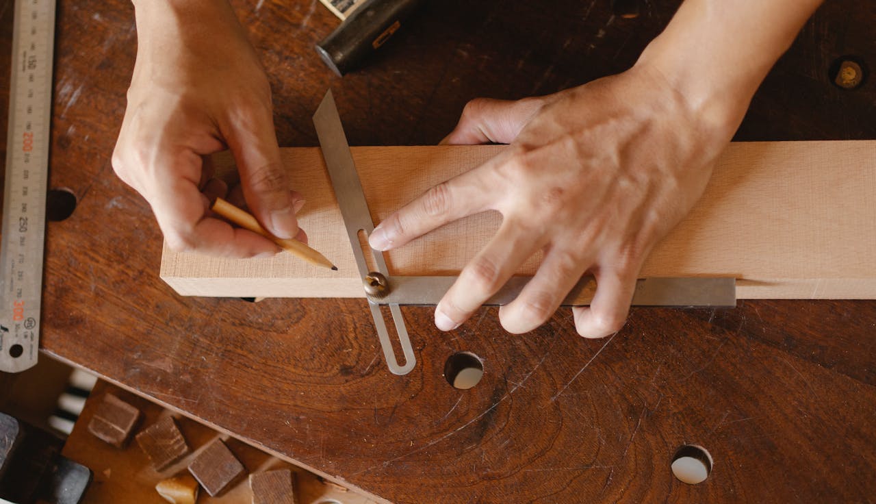The Art of Drawing Readers In: Your attractive post title goes here High angle of skilled man using bevel tool and pencil while measuring angle of cut on workshop